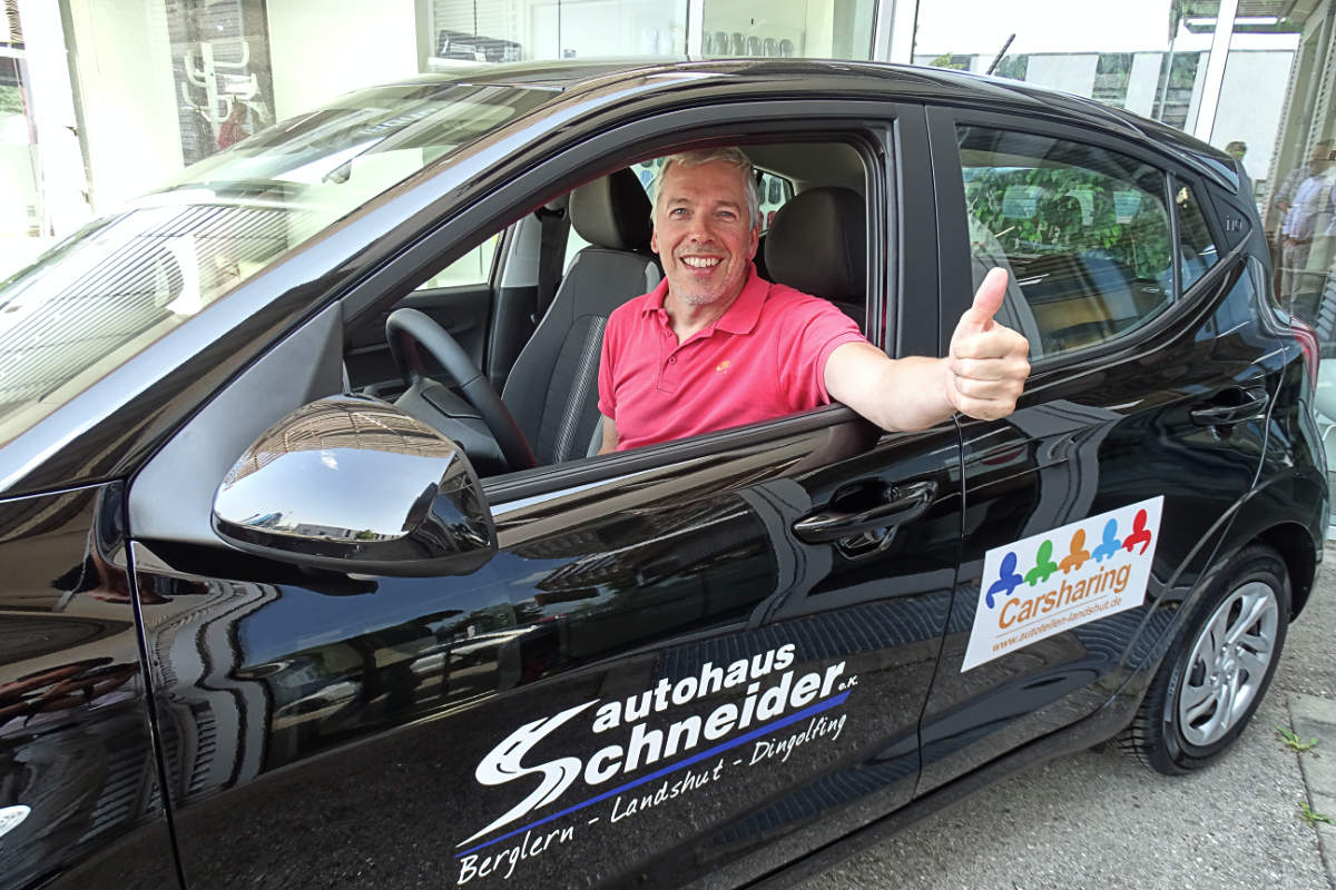 Ein lächelnder Mann sitzt im schwarzen Hyundai und zeigt den Daumen nach oben