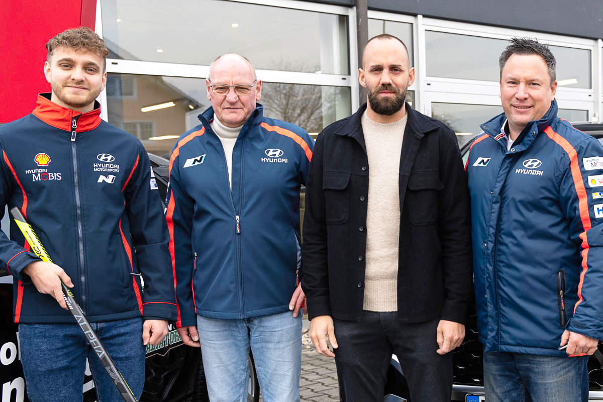 Familie Schneider und die Mitglieder der Erding Gladiators stehen vor dem Autohaus Schneider.